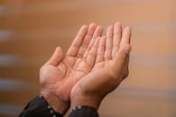 Close-up of hands in prayer gesture, symbolizing Islamic devotion. Captured indoors in Sulawesi Selatan, Indonesia.